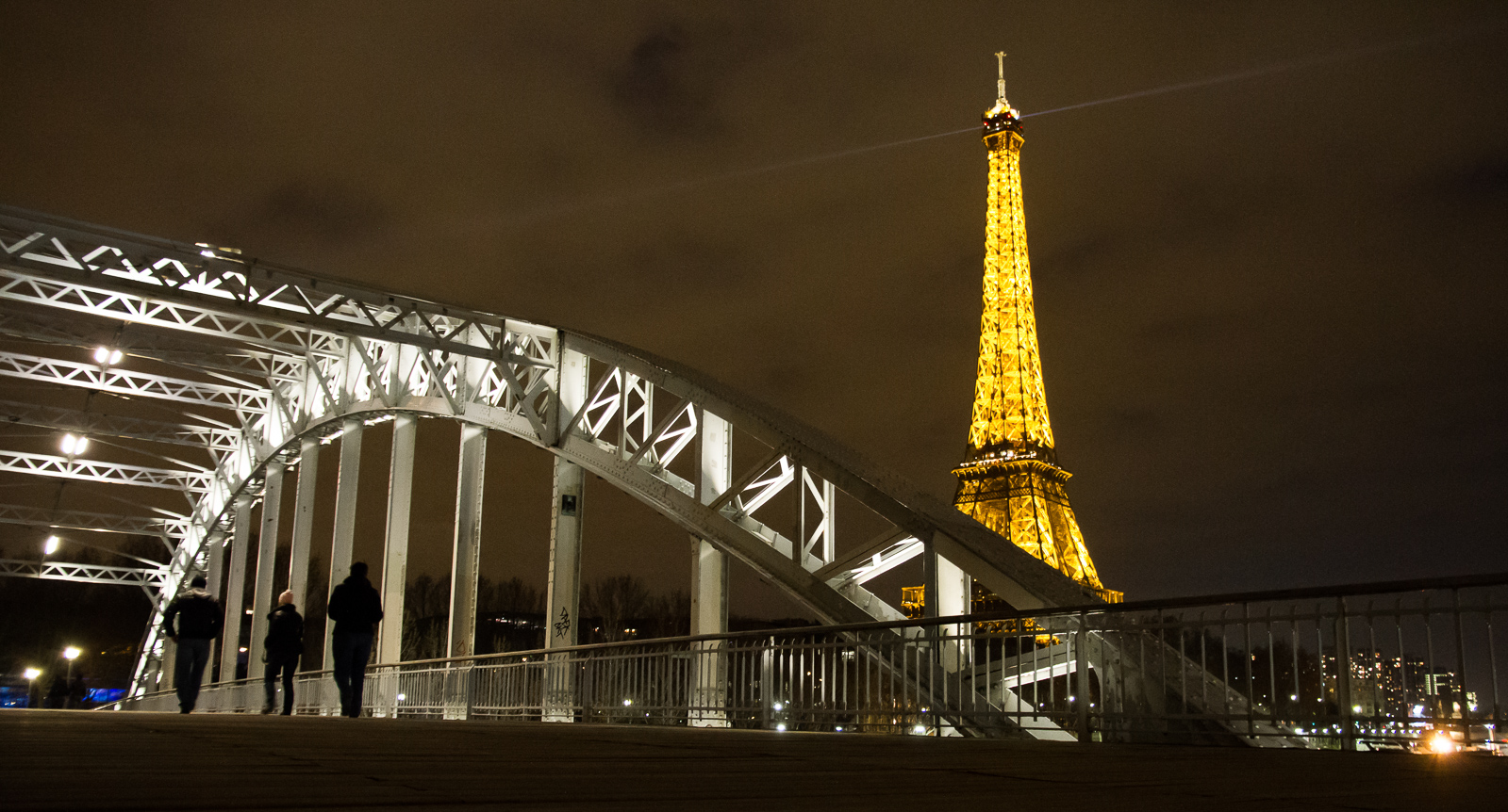 Getting to Paris from the airport by car with a view on the Eiffel Tower at night.