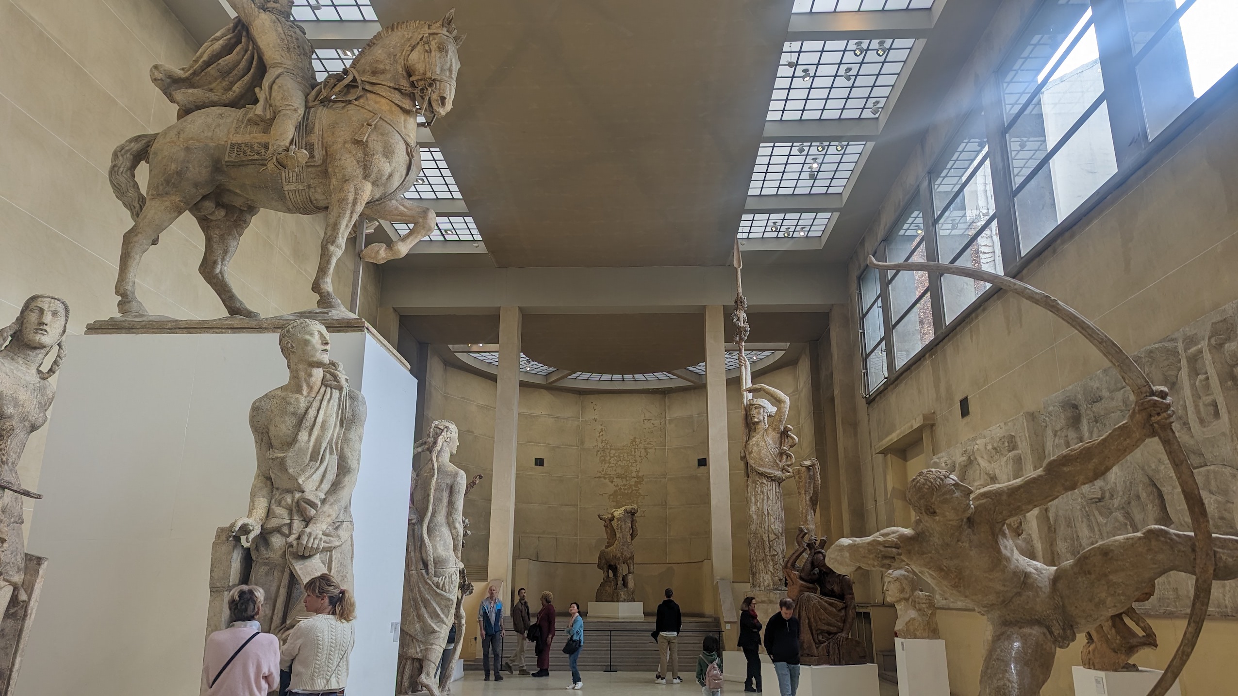The Musée Bourdelle is filled with visitors, marveling at the statues.