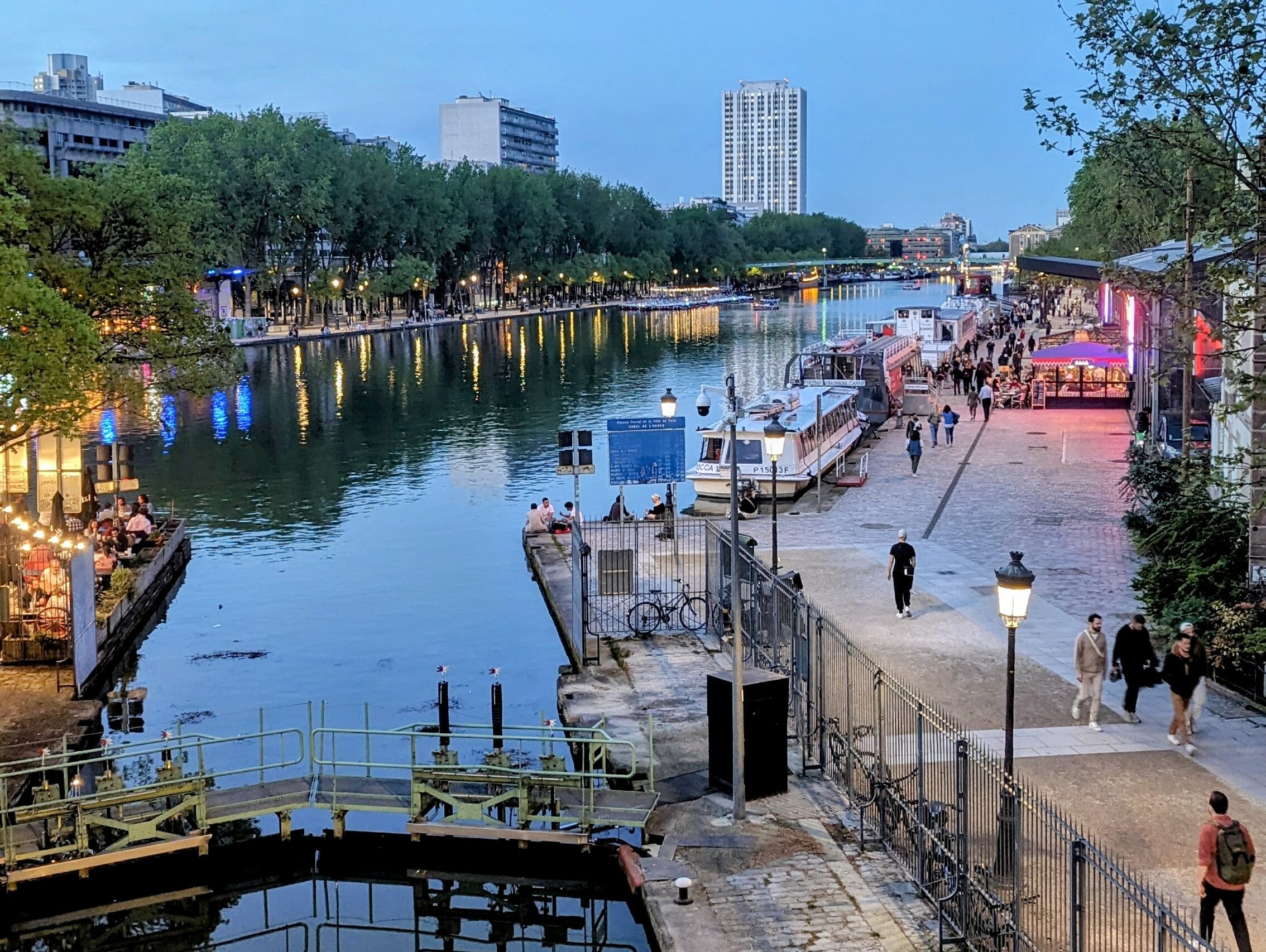 The crowded and lively Canal de l'Ourcq at dusk.