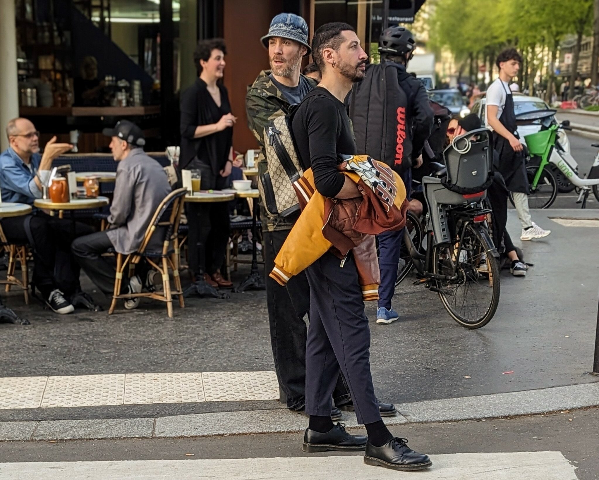 Two bobos on the street outside a café near Canal de l'Ourcq in Paris.