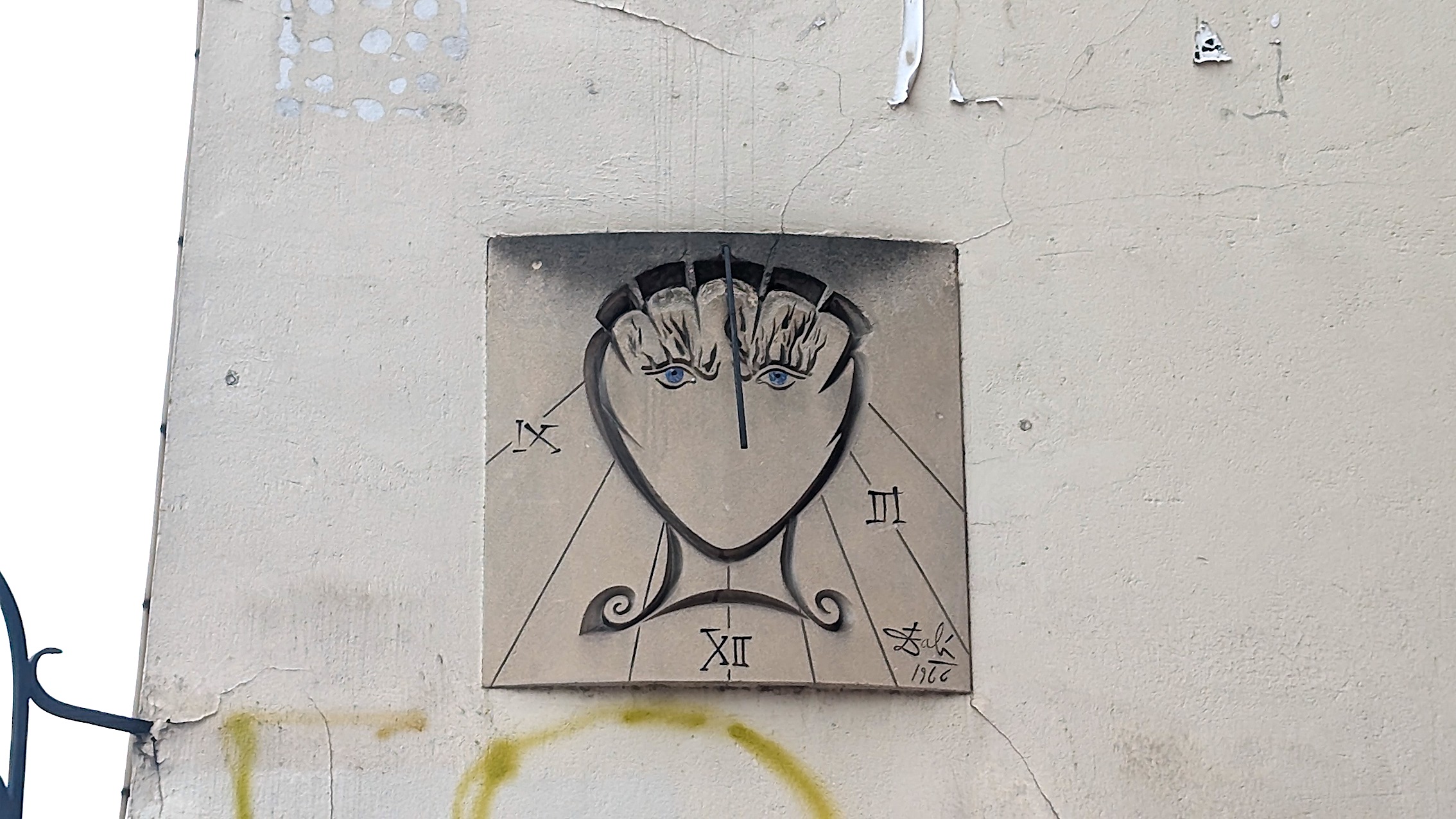 A close up of Salvador Dali's Sundial sealed on a wall in the Latin Quarter in Paris.