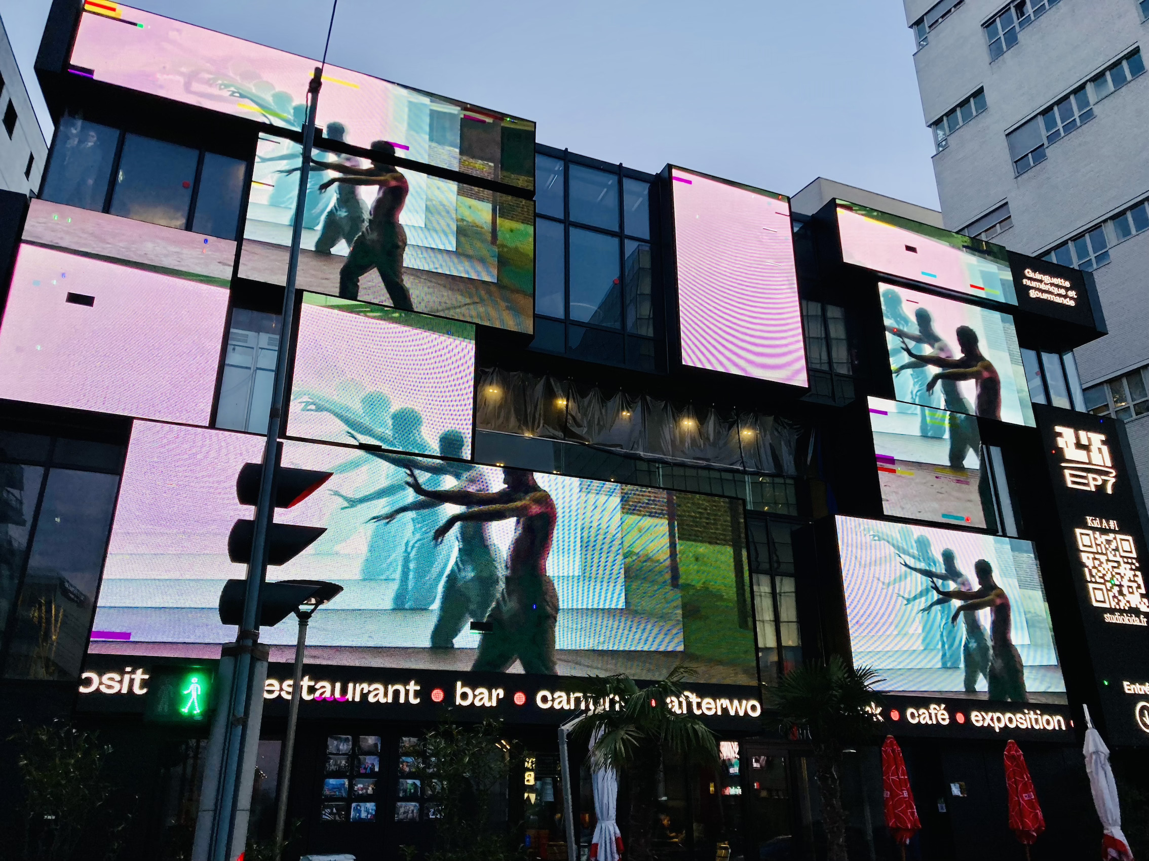 A restaurant with big screens on its facade in the modern part of the 13th arrondissement in Paris.